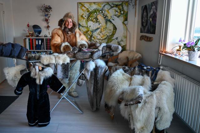 Musher Johanne Bech shows the traditional clothing she wears when driving her sled dogs at her home in Sisimiut, Greenland on February 2, 2026. (Photo by Ina FASSBENDER / AFP)
