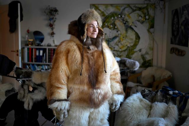 Musher Johanne Bech stands in the traditional clothing she wears when driving her sled dogs, at her home in Sisimiut, Greenland on February 2, 2026. (Photo by Ina FASSBENDER / AFP)