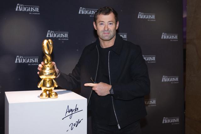 French artist and creator of the trophy, Auguste, poses during the second edition of the Auguste de l'Humour awards ceremony for stand-up comedy and humorous performances at the "Nouveau Siecle" venue in Lille, northern France, on February 2, 2026. Elodie Poux was crowned comedian of the year at the second edition of the Auguste de l'humour awards in Lille on February 2, 2026, during a ceremony that sought to honour women after criticism of the overrepresentation of men among the nominees. (Photo by Sameer Al-DOUMY / AFP)