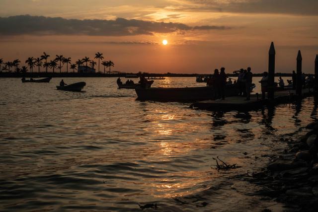 Residents attend the Procession of the Virgin, taking an image of the Virgin of Candelaria along the Papaloapan River during the Candelaria festivities in Tlacotalpan, Veracruz state, Mexico, on February 2, 2026. (Photo by Hector QUINTANAR / AFP)