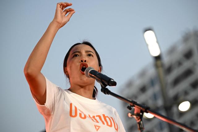 (FILES) People’s Party MP Rukchanok Srinork speaks during a campaign rally ahead of the general election, in Bangkok on January 25, 2026. Thousands of young orange-clad supporters cheered the rallies of Thailand's most popular political party ahead of elections on February 8, but few expect it to take power. While the People's Party is far ahead in the polls, promising to tackle corruption and reform Thailand's strict royal insult laws, even some of the party's lawmakers have their doubts. (Photo by Lillian SUWANRUMPHA / AFP)