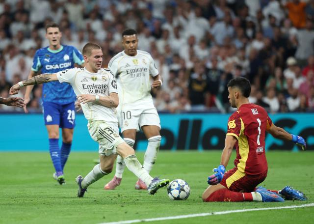 (FILES) Real Madrid's Argentine forward #30 Franco Mastantuono challenges Marseille's Argentine goalkeeper #01 Geronimo Rulli during the UEFA Champions League first round day 1 football match between Real Madrid CF and Olympique de Marseille at the Santiago Bernabeu stadium in Madrid on September 16, 2025. Argentine footballers are emigrating to Europe at increasingly younger ages, a risky gamble for all the actors in the market, but also for the much-touted renewal of the reigning world champion national team. (Photo by Pierre-Philippe MARCOU / AFP)