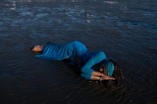 A believer offers tribute to Iemanja, the Goddess of the Sea of the Afro-American religion Umbanda, at Ramirez Beach in Montevideo on February 2, 2026. (Photo by Eitan ABRAMOVICH / AFP)