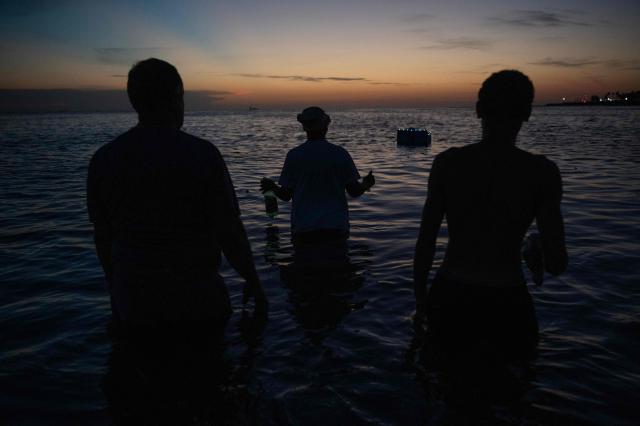 Believers offer tribute to Iemanja, the Goddess of the Sea of the Afro-American religion Umbanda, at Ramirez Beach in Montevideo on February 2, 2026. (Photo by Eitan ABRAMOVICH / AFP)