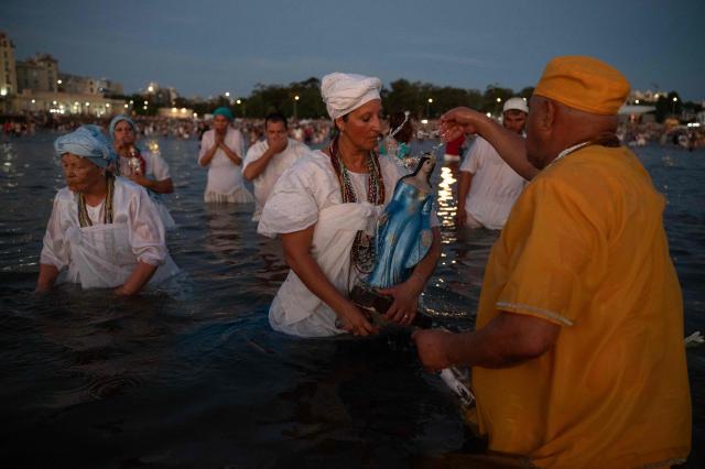 Believers offer tribute to Iemanja, the Goddess of the Sea of the Afro-American religion Umbanda, at Ramirez Beach in Montevideo on February 2, 2026. (Photo by Eitan ABRAMOVICH / AFP)