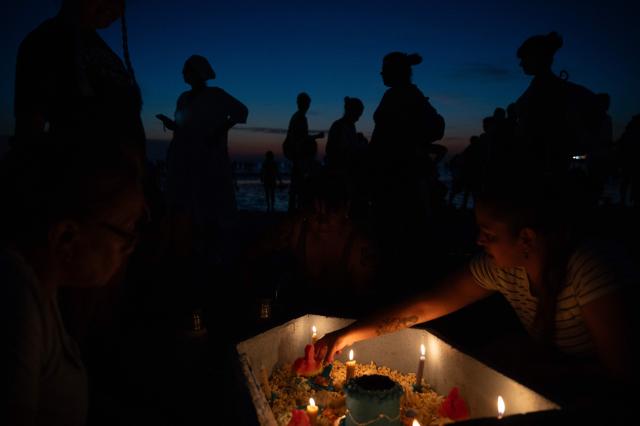 Believers offer tribute to Iemanja, the Goddess of the Sea of the Afro-American religion Umbanda, at Ramirez Beach in Montevideo on February 2, 2026. (Photo by Eitan ABRAMOVICH / AFP)