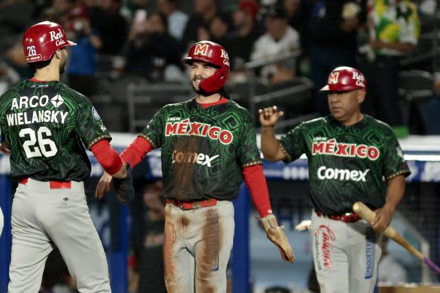 Charros de Jalisco's #26 Michael Wielansky celebrates with a teammate after scoring a run in the first inning of the Caribbean Series baseball tournament fourth game between Mexico's Charros de Jalisco and Panama's Federales de Chiriqui at the Panamerican Stadium in Jalisco, Mexico, on February 2, 2026. (Photo by Ulises Ruiz / AFP)