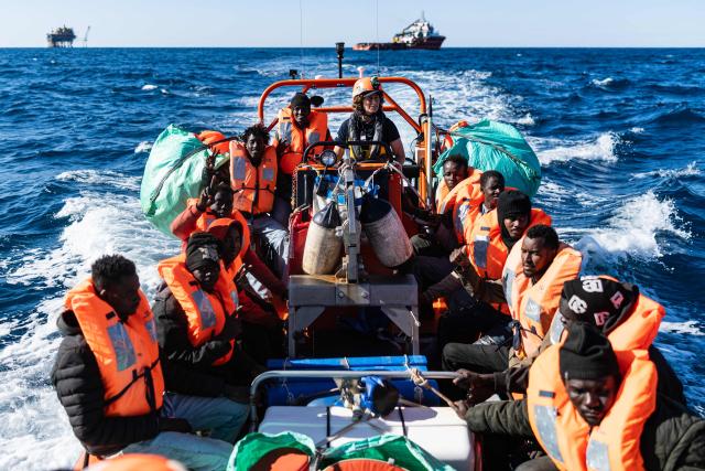 (FILES) Migrants sit on board a RHIB (Rigid inflatable boat) after being evacuated by crew members of the “Ocean Viking” rescue ship from the oil tanker the 'Maridive 703' in the search-and-rescue zone of the international waters between Malta and Tunisia, on December 31, 2025. Nearly six months after coming under fire off the coast of Libya, the "Ocean Viking", an ambulance ship chartered by SOS Mediterranee, has returned to sea for the first time in recent weeks, rescuing more than 120 migrants in a sometimes tense context. (Photo by Sameer Al-DOUMY / AFP)