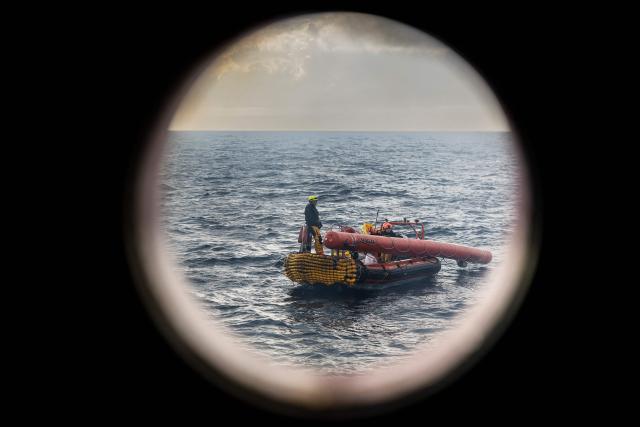 (FILES) Crew members of the “Ocean Viking” rescue ship, operated by the French NGO SOS Mediterranee, take part in a team exercise to prepare for a rescue situation at sea with a "RHIB", an inflatable dinghy, on the way to the search-and-rescue zone in international waters off the coast of Libya, from Augusta, Sicily, southern Italy on December 26, 2025. Nearly six months after coming under fire off the coast of Libya, the "Ocean Viking", an ambulance ship chartered by SOS Mediterranee, has returned to sea for the first time in recent weeks, rescuing more than 120 migrants in a sometimes tense context. (Photo by Sameer Al-DOUMY / AFP)