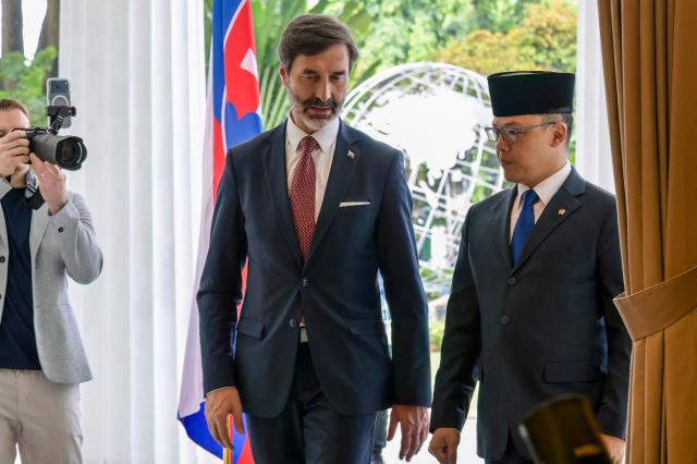 Indonesian Foreign Minister Sugiono (R) walks with his Slovak counterpart Juraj Blanar (L) during their meeting in Jakarta on February 3, 2026. (Photo by BAY ISMOYO / AFP)