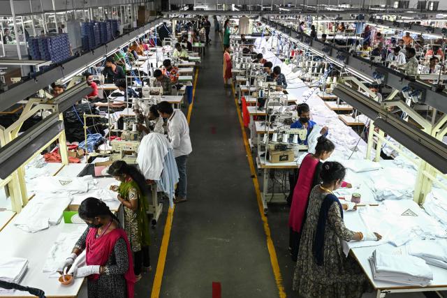 (FILES) In this photograph taken on September 23, 2025, employees work at a garment factory in Tiruppur, in India's southern state of Tamil Nadu. Indian exporters on February 3 hailed a breakthrough trade deal with Washington after US President Donald Trump slashed tariffs on Indian goods, ending months of tensions that had rattled markets and squeezed key sectors. (Photo by R. Satish BABU / AFP)