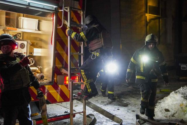 Ukrainian emergency workers are seen at the site of an apartment building that was damaged following a Russian air attack in Kyiv early on February 3, 2026, amid the Russian invasion of Ukraine. Russia resumed strikes on Kyiv on February 3, Ukrainian officials said, as a week-long truce announced by US President Donald Trump gave way to renewed attacks in freezing conditions. (Photo by Serhii Okunev / AFP)