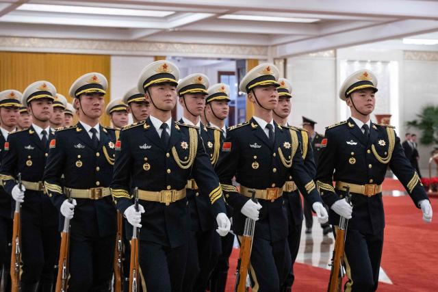 Guards march during a welcome ceremony with Chinese President Xi Jinping and Uruguay's President Yamandu Orsi at the Great Hall of the People in Beijing on February 3, 2026. (Photo by JESSICA LEE / POOL / AFP)