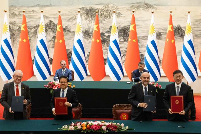 Chinese President Xi Jinping (top R) attends a signing ceremony with Uruguay's President Yamandu Orsi (top L) at the Great Hall of the People in Beijing on February 3, 2026. (Photo by JESSICA LEE / POOL / AFP)