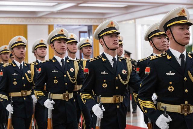 Guards march during a welcome ceremony with Chinese President Xi Jinping and Uruguay's President Yamandu Orsi at the Great Hall of the People in Beijing on February 3, 2026. (Photo by JESSICA LEE / POOL / AFP)