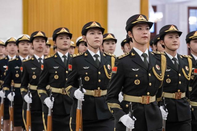 Guards march during a welcome ceremony with Chinese President Xi Jinping and Uruguay's President Yamandu Orsi at the Great Hall of the People in Beijing on February 3, 2026. (Photo by JESSICA LEE / POOL / AFP)