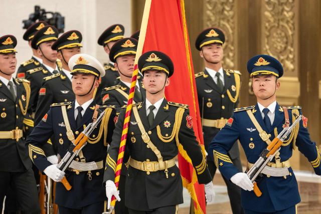 Honour guards march during a welcome ceremony with Chinese President Xi Jinping and Uruguay's President Yamandu Orsi at the Great Hall of the People in Beijing on February 3, 2026. (Photo by JESSICA LEE / POOL / AFP)