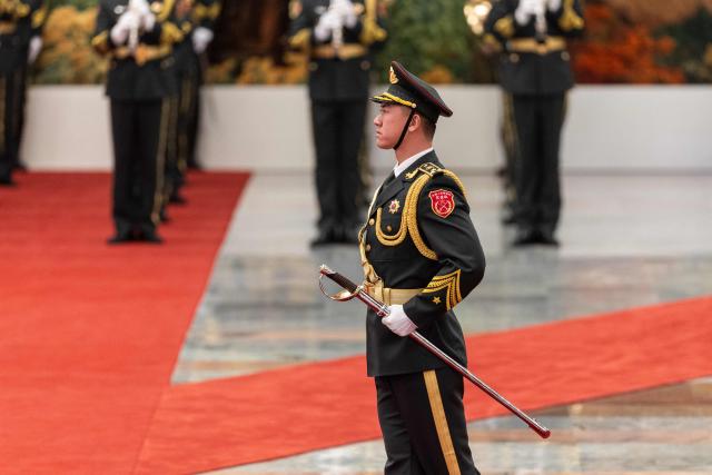 An honour guard marches during a welcome ceremony with Chinese President Xi Jinping and Uruguay's President Yamandu Orsi at the Great Hall of the People in Beijing on February 3, 2026. (Photo by JESSICA LEE / POOL / AFP)