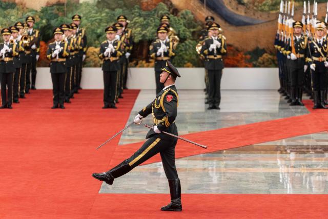An honour guard marches during a welcome ceremony with Chinese President Xi Jinping and Uruguay's President Yamandu Orsi at the Great Hall of the People in Beijing on February 3, 2026. (Photo by JESSICA LEE / POOL / AFP)