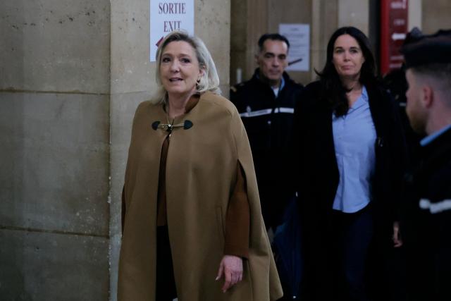 President of the parliamentary group of the French far-right Rassemblement National (RN) party, Marine Le Pen (L) arrives for her appeal trial on charges of embezzlement of European public funds in a case of alleged European Parliament fake jobs at the Palais de Justice in Paris on February 3, 2026. Le Pen is called to the stand in the appeal trial in Paris of the parliamentary assistants of the National Front, where she is playing for her candidacy for the 2027 presidential election. Twelve of the accused, as well as the far-right party itself, have appealed against the verdict while another 12 people -- including one of Le Pen's sisters -- have decided to accept their convictions without appealing. The public prosecutor's office is expected to announce its charges against Marine Le Pen, the National Rally party, and ten party officials on February 3, 2026. (Photo by Thomas SAMSON / AFP)