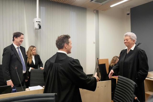 State Attorney and Prosecutor Sturla Henriksboe (C) greets defence lawyer of Marius Borg Hoiby, Ellen Holager Andenaes (R) at the District Court in Oslo on February 3, 2026, prior to the start of the trial against Marius Borg Hoiby, son of Norway's Crown Princess Mette-Marit. In the biggest scandal to rock Norway's monarchy, the son of Crown Princess Mette-Marit goes on trial on February 3, accused of raping four women, as well as drug and assault offences. Marius Borg Hoiby, Mette-Marit's 29-year-old son from a relationship before she married Crown Prince Haakon, has been charged with a total of 38 counts, some of which date back to 2018. He faces up to 16 years in prison if the Oslo district court finds him guilty. The trial, scheduled to last until March 19, is expected to attract intense media coverage. (Photo by Terje Pedersen / NTB / AFP) / Norway OUT