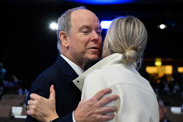 Prince's Albert II of Monaco (L) is welcomed by IOC President Kirsty Coventry (R) upon arrival on the first day of the 145th IOC Session, in Milan, northern Italy, on February 3, 2026. (Photo by Daniel MUÑOZ / AFP)