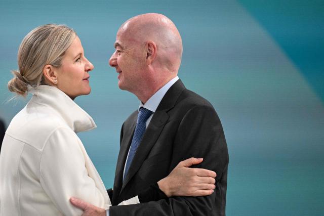 IOC President Kirsty Coventry (L) welcomes FIFA President Gianni Infantino (R) delivers  during the first day of the 145th IOC Session, in Milan, northern Italy, on February 3, 2026. (Photo by Daniel MUÑOZ / AFP)