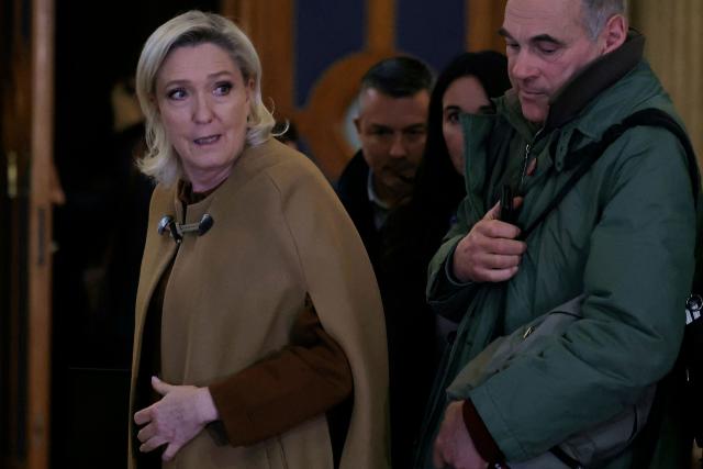 President of the parliamentary group of the French far-right Rassemblement National (RN) party, Marine Le Pen (L) leaves after a break during her appeal trial on charges of embezzlement of European public funds in a case of alleged European Parliament fake jobs at the Palais de Justice in Paris on February 3, 2026. Le Pen is called to the stand in the appeal trial in Paris of the parliamentary assistants of the National Front, where she is playing for her candidacy for the 2027 presidential election. Twelve of the accused, as well as the far-right party itself, have appealed against the verdict while another 12 people -- including one of Le Pen's sisters -- have decided to accept their convictions without appealing. The public prosecutor's office is expected to announce its charges against Marine Le Pen, the National Rally party, and ten party officials on February 3, 2026. (Photo by Thomas SAMSON / AFP)