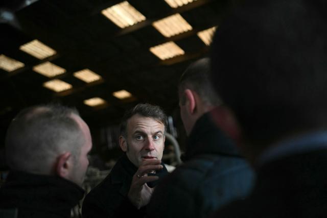 France's President Emmanuel Macron (C) visits the Py borthers farm in Vallerois-le-Bois, eastern France, on February 3, 2026. (Photo by SEBASTIEN BOZON / POOL / AFP)