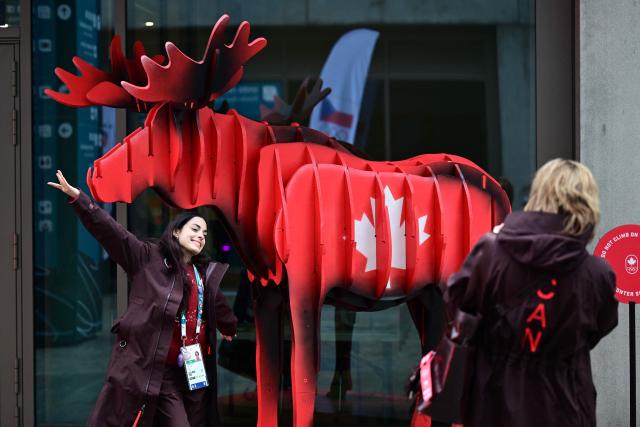 Team Canada figure skater Madeline Schizas poses with a statue of a moose at the Canada quarters in the Olympic Village ahead of the Milano Cortina 2026 Winter Olympics in Milan on February 3, 2026. (Photo by PIERO CRUCIATTI / AFP)