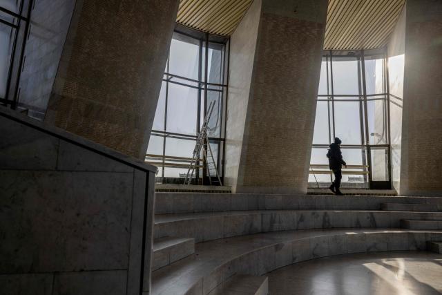 A man walks by damaged windows following a Russian strike in The National Museum of the History of Ukraine in the Second World War in Kyiv on February 3, 2026, amid the Russian invasion of Ukraine. (Photo by Tetiana DZHAFAROVA / AFP)