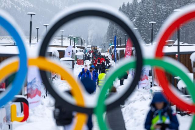 Athletes and team members walk along the accomodation of the Olympic Village ahead of the Milano Cortina 2026 Winter Olympics in Cortina d'Ampezzo on February 3, 2026. (Photo by Odd ANDERSEN / AFP)