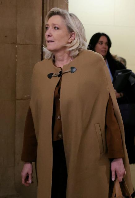 President of the parliamentary group of the French far-right Rassemblement National (RN) party, Marine Le Pen arrives after a break during her appeal trial on charges of embezzlement of European public funds in a case of alleged European Parliament fake jobs at the Palais de Justice in Paris on February 3, 2026. Le Pen is called to the stand in the appeal trial in Paris of the parliamentary assistants of the National Front, where she is playing for her candidacy for the 2027 presidential election. Twelve of the accused, as well as the far-right party itself, have appealed against the verdict while another 12 people -- including one of Le Pen's sisters -- have decided to accept their convictions without appealing. The public prosecutor's office is expected to announce its charges against Marine Le Pen, the National Rally party, and ten party officials on February 3, 2026. (Photo by Thomas SAMSON / AFP)