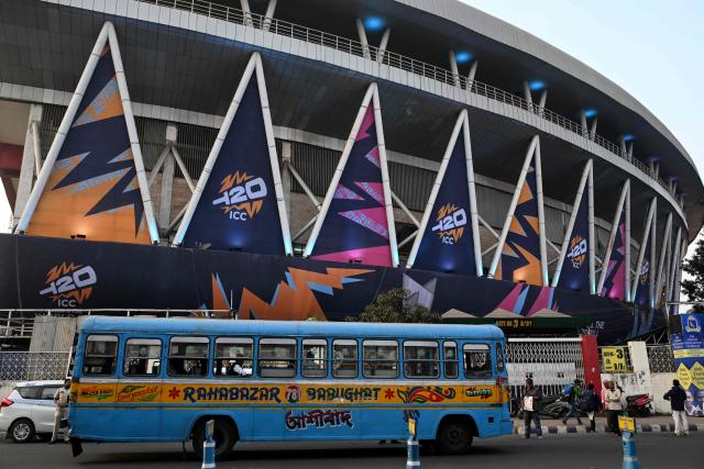 A bus rides past the Eden Gardens stadium, decorated for the upcoming 2026 ICC Men's T20 Cricket World Cup in Kolkata on February 3, 2026. (Photo by Dibyangshu SARKAR / AFP)