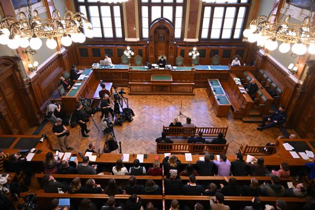(FILES) A general view taken on February 21, 2025 shows a courtroom for a preliminary court hearing of German anti-fascist activist Maja T (bench, C-R) in Budapest for allegedly participating in attacks against presumed neo-Nazis on the streets of the Hungarian capital. A Hungarian court in Budapest is expected to give a verdict on January 4, 2026 in the case of Maja T., a non-binary anti-fascist activist from Germany, who faces up to 24 years in jail on charges of assault in a closely watched and controversial trial. The German constitutional court has slammed the 2024 estradition of Maja T., 25, over potentially dangerous prison conditions in Hungary, especially for LGBTQ people. (Photo by Attila KISBENEDEK / AFP)
