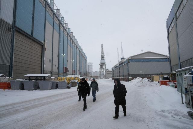 Workers walk at the premises of Helsinki Shipyard on January 28, 2026 in Helsinki, Finland. Finland is building a new fleet of icebreakers for the US but the US President plans for Greenland, which he covets, and tense US-EU ties have raised concerns over the deal. (Photo by Alessandro RAMPAZZO / AFP)