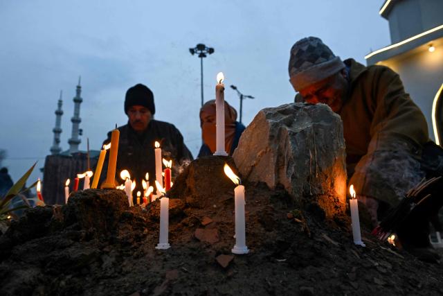 Kashmiri Shiite Muslims offer prayers and light candles over their relatives' graves to mark Shab-e-Barat, or the night of forgiveness, at a graveyard in Srinagar on February 3, 2026. (Photo by Tauseef MUSTAFA / AFP)