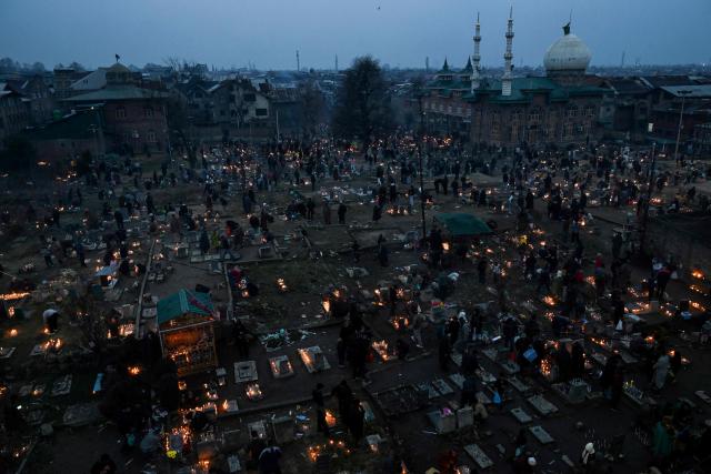Kashmiri Shiite Muslims offer prayers and light candles over their relatives' graves to mark Shab-e-Barat, or the night of forgiveness, at a graveyard in Srinagar on February 3, 2026. (Photo by Tauseef MUSTAFA / AFP)
