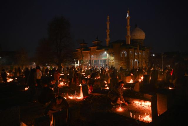 Kashmiri Shiite Muslims offer prayers and light candles over their relatives' graves to mark Shab-e-Barat, or the night of forgiveness, at a graveyard in Srinagar on February 3, 2026. (Photo by Tauseef MUSTAFA / AFP)
