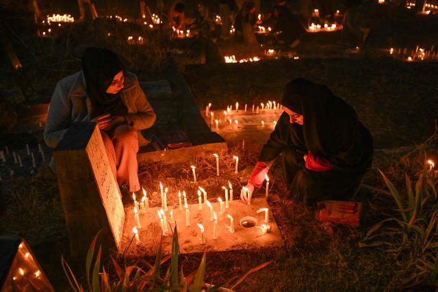 Kashmiri Shiite Muslims offer prayers and light candles over their relatives' graves to mark Shab-e-Barat, or the night of forgiveness, at a graveyard in Srinagar on February 3, 2026. (Photo by Tauseef MUSTAFA / AFP)