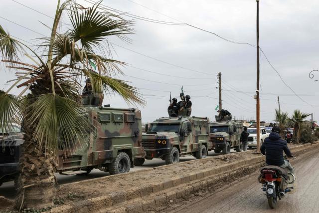 Syrian government forces driving along a road as they enter the Kurdish-majority city of Qamishli on February 3, 2026. Syrian government forces started entering Qamishli on February 3, under an integration deal agreed with the Kurds last week, state media reported. The move comes after security personnel entered the mixed Kurdish-Arab city of Hasakeh and the countryside around the Kurdish town of Kobane a day earlier, as part of the comprehensive agreement to gradually integrate Kurdish forces and institutions into the state. (Photo by Bakr ALkasem / AFP)