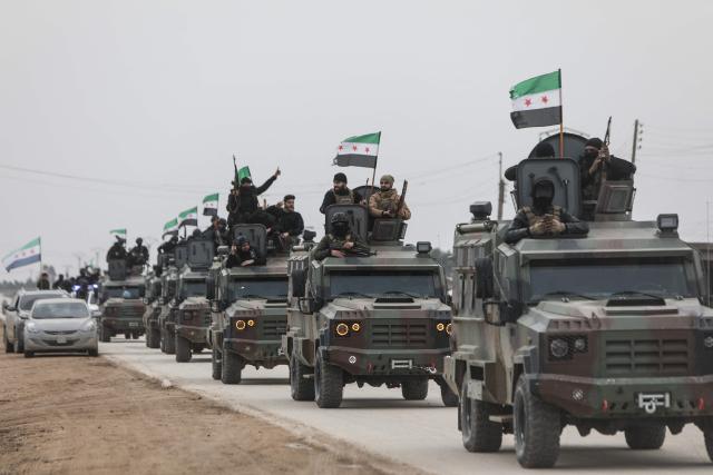 Syrian government forces drive along a road as they enter the Kurdish-majority city of Qamishli on February 3, 2026. Syrian government forces started entering Qamishli on February 3, under an integration deal agreed with the Kurds last week, state media reported. The move comes after security personnel entered the mixed Kurdish-Arab city of Hasakeh and the countryside around the Kurdish town of Kobane a day earlier, as part of the comprehensive agreement to gradually integrate Kurdish forces and institutions into the state. (Photo by Bakr ALkasem / AFP)