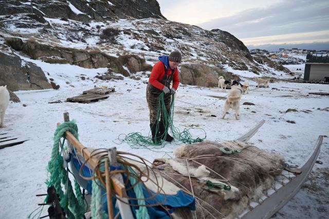 Musher Johanne Bech prepares her sled for a training ride near her home in Sisimiut, Greenland on February 3, 2026. (Photo by Ina FASSBENDER / AFP)