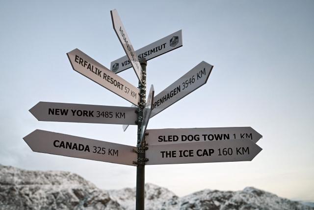 A sign indicates the distance to Copenhagen and New York at the city in Sisimiut, Greenland on February 3, 2026. (Photo by Ina FASSBENDER / AFP)