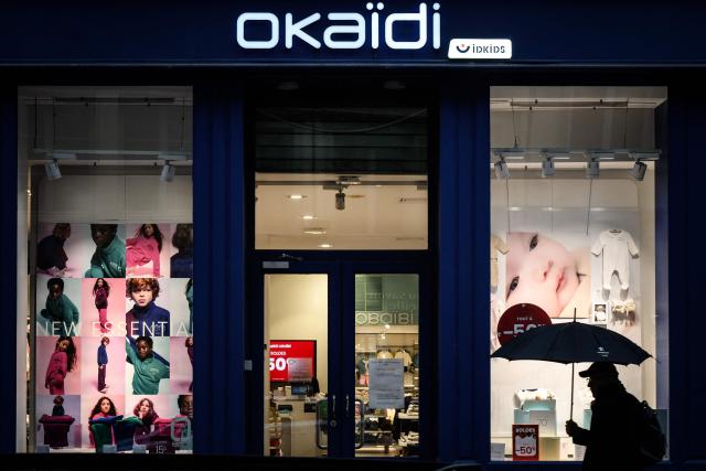 (FILES) A pedestrian walks past an Okaidi children's clothing shop in Lyon, southeastern France on January 27, 2026. The IDKIDS group, which owns the Okaidi children's clothing brand, announced on February 3, 2026, that it is placed under court ordered restructuring for most of its brands in France, where the group employs 2,000 people, according to unions and management. (Photo by JEFF PACHOUD / AFP)