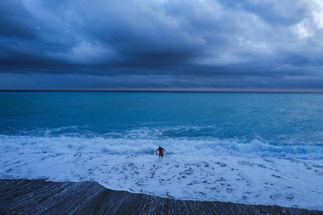 A man comes out after a bath on the Mediterranean sea on the French riviera city of Nice, on February 3, 2026. (Photo by Valery HACHE / AFP)
