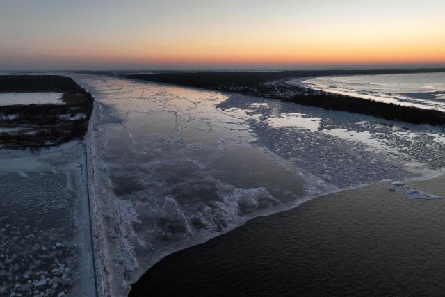 This aerial photograph taken on February 3, 2026 shows the frozen mouth of the Vistula River near Mikoszewo, northern Poland. (Photo by Sergei GAPON / AFP)