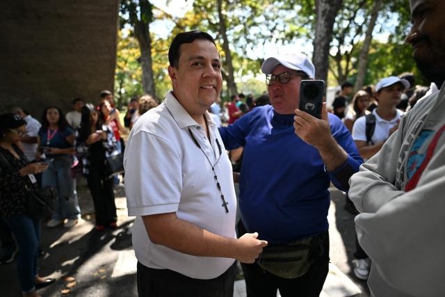 Human rights activist Javier Tarazon greets a supporter during a demonstration at the Central University of Venezuela in Caracas on February 3, 2026. Venezuela's acting President Delcy Rodriguez announced on January 30 a proposal for mass amnesty in the country, in her latest major reform since the US toppling of Nicolas Maduro just weeks ago. (Photo by Juan BARRETO / AFP)