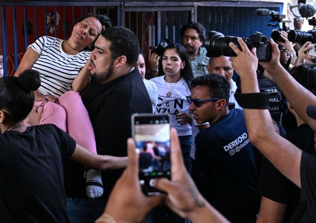 The mother of a young woman who is a political prisoner faints during a speech in which she is requesting proof of life for her daughter, during a demonstration at the Central University of Venezuela in Caracas on February 3, 2026. Venezuela's acting President Delcy Rodriguez announced on January 30 a proposal for mass amnesty in the country, in her latest major reform since the US toppling of Nicolas Maduro just weeks ago. (Photo by Juan BARRETO / AFP)