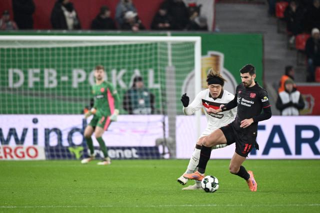 St Pauli's Japanese defender #15 Tomoya Ando (L) and Bayer Leverkusen's French forward #11 Martin Terrier vie for the ball during the German Cup (DFB-Pokal) quartefinal football match between Bayer 04 Leverkusen and FC St. Pauli in Leverkusen, western Germany on February 3, 2026. (Photo by UWE KRAFT / AFP) / DFB REGULATIONS PROHIBIT ANY USE OF PHOTOGRAPHS AS IMAGE SEQUENCES AND QUASI-VIDEO.